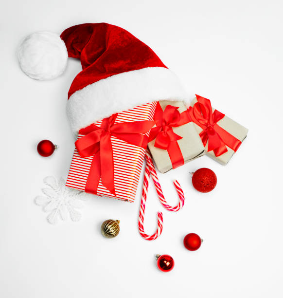istock Santa hat with gifts on a light background. 1341525403