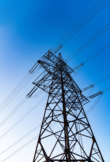 istock Dark silhouette of electric wire construction. Energy technologies tower shadows. 1341525799