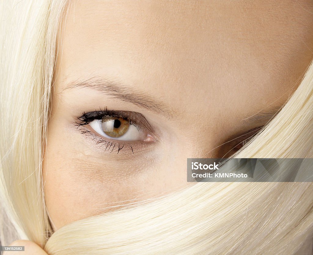 beautiful look brown eye poping out of the blond hair Adult Stock Photo