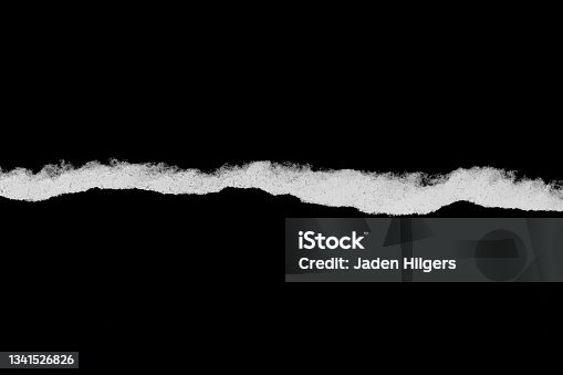 istock Ripped, torn paper edge isolated white on black, paper tear with space for copy 1341526826