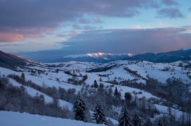 istock Winter sunset in the mountains. Snow-covered mountain range 1341527923