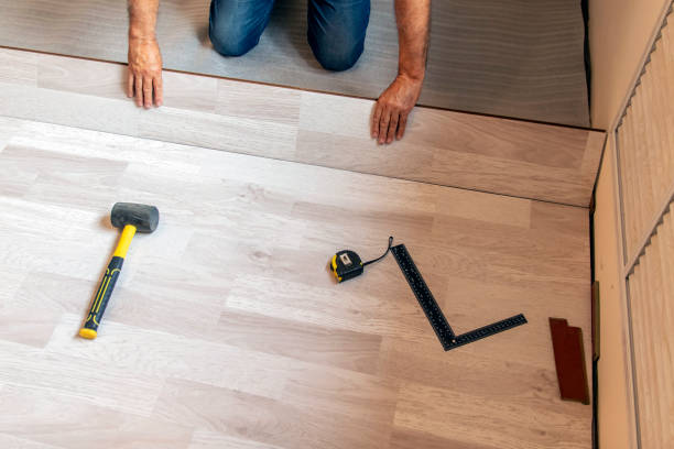 istock Locking longitudinal joint, floating floor laying technology. Laying laminate flooring. Selective focus. 1341528959