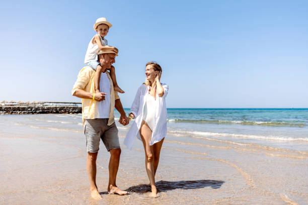 istock Family on beach walk 1341529373