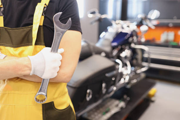 istock Locksmith master holds wrench in garage closeup 1341530350