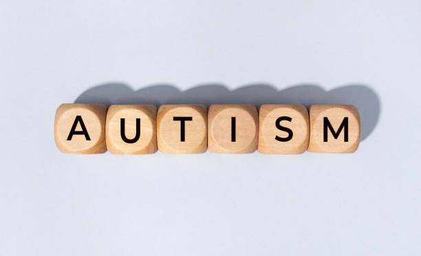 Autism word on wooden block stock photo