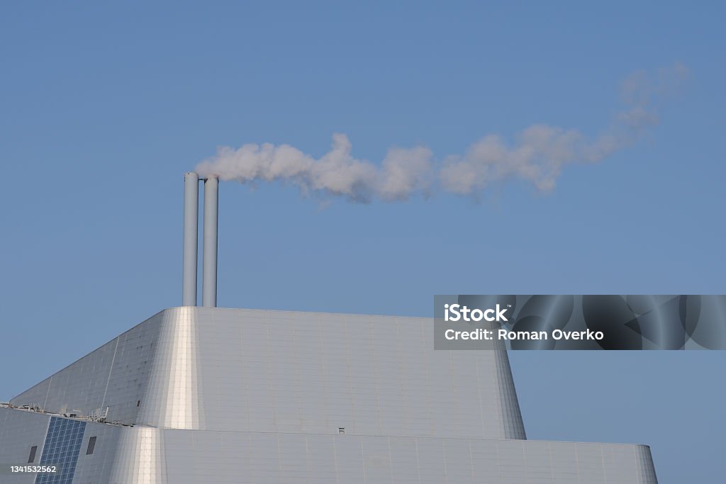 Covanta Plant (Dublin Waste to Energy) against clear blue sky Beautiful closeup bright view of Covanta Plant (Dublin Waste to Energy) against clear blue sky seen from Sandymount Beach, Dublin, Ireland. Poolbeg Incinerator. Ireland Stock Photo