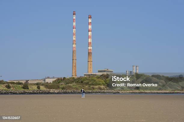 Iconic Poolbeg Power Station Chimneys And Poolbeg Ccgt Station Against Clear Blue Sky Stock Photo - Download Image Now