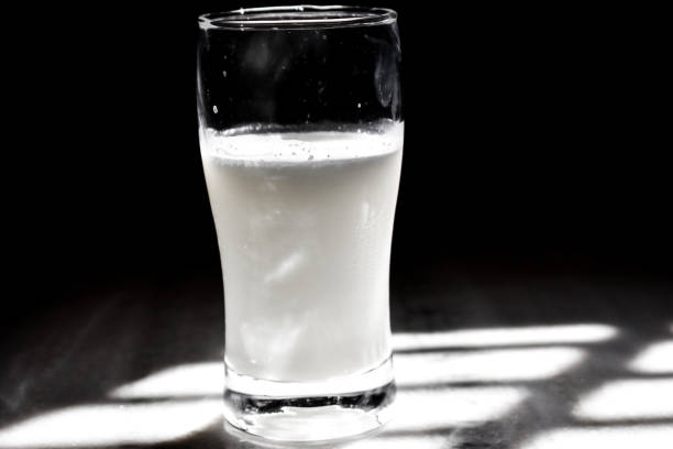 istock Glass of milk on table on black background with copy space 1341533186