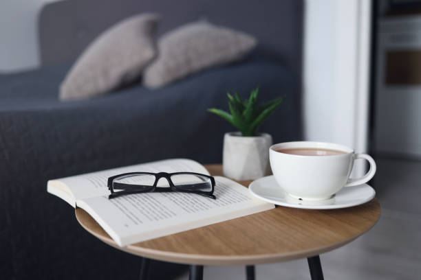 istock Cup of tea with books on table in room 1341535029