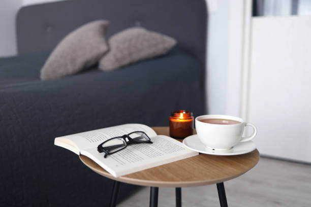 istock Cup of tea with books on table in room 1341535032
