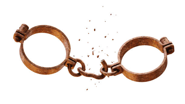 Rusty metallic handcuffs with a broken chain link and pieces of metal falling off, isolated on white background. Rusty metallic handcuffs with a broken chain link and pieces of metal falling off, isolated on white background. medieval restraints stock pictures, royalty-free photos & images