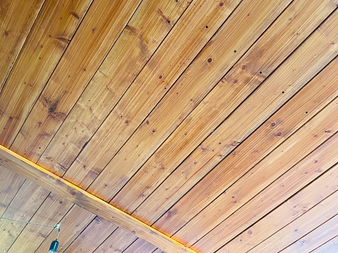 Wooden roof of a building with hanging electric bulb