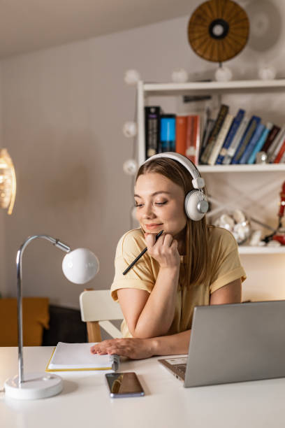 istock Young woman attending online class at home 1341538380