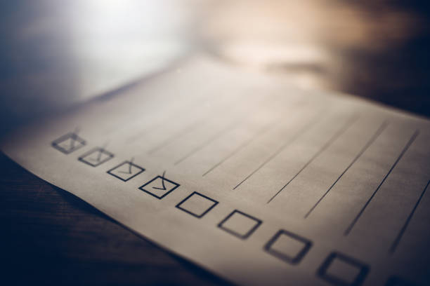 incomplete checklist on a wooden desk - checkbox check mark checklist clipboard imagens e fotografias de stock