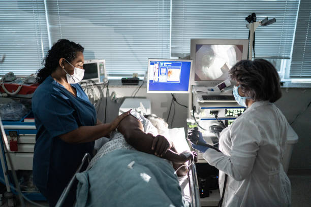 istock Doctor examining patient with endoscope 1341539406