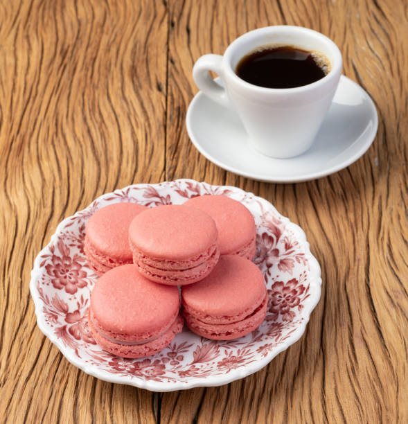 istock Berry macarons on a plate with coffee over wooden table 1341540253