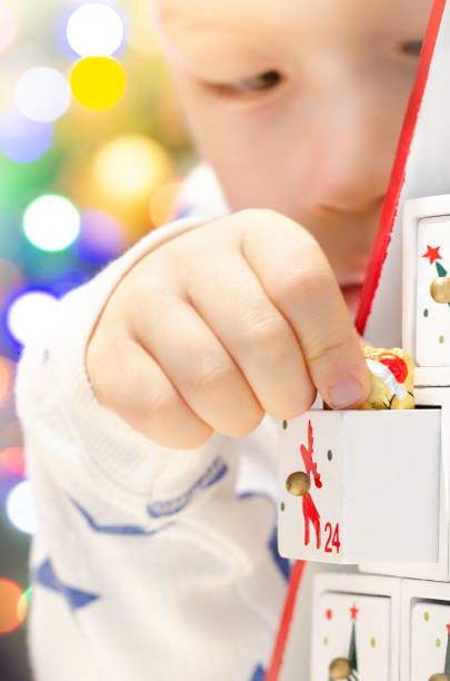 istock Wooden advent calendar Christmas tree and child 1341542828