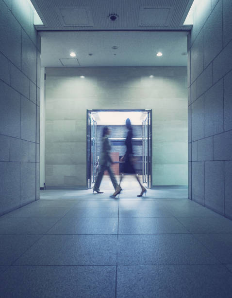 istock Two employees walking at corporate headquarters 1341546332
