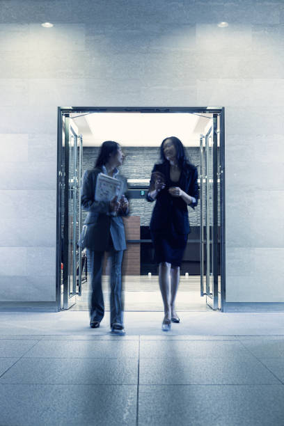 istock Japanese business colleagues talking at work 1341546362