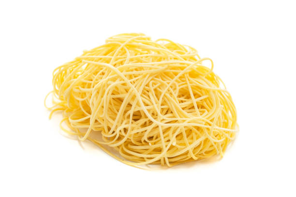 istock Fresh uncooked capellini pasta isolated on a white background 1341546363