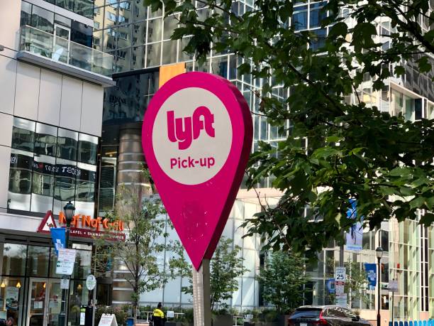 Lyft Ride Sharing Sign Philadelphia, Pennsylvania United States - August 31 2021: Lyft mobile app ride sharing sign for a pickup station with bus. crowdsourced taxi stock pictures, royalty-free photos & images