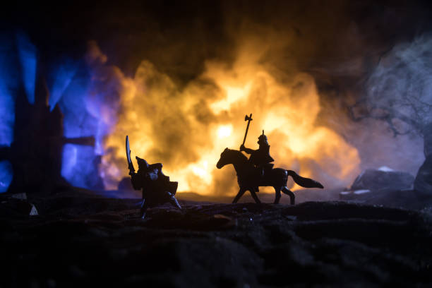 istock Medieval battle scene with cavalry and infantry. Silhouettes of figures as separate objects, fight between warriors on dark toned foggy background with medieval castle. 1341547542