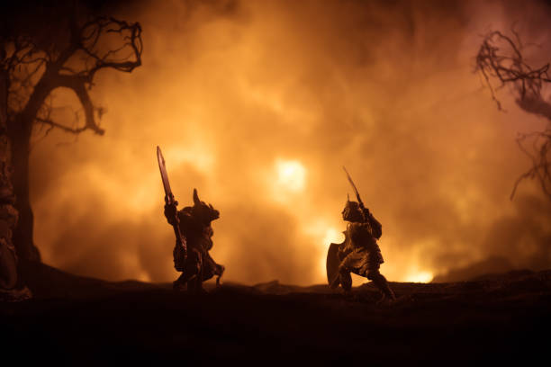 istock Medieval battle scene with cavalry and infantry. Silhouettes of figures as separate objects, fight between warriors on dark toned foggy background with medieval castle. 1341547545