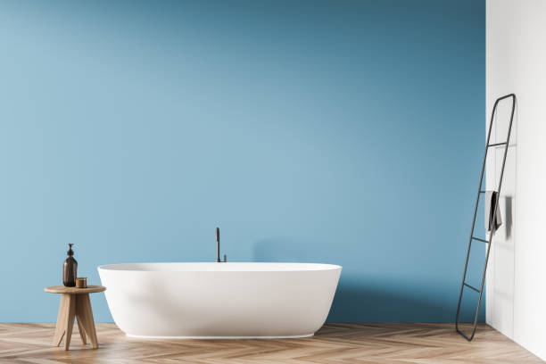 istock Oval white ceramic bathtub with minimalist design in blue bathroom background 1341548452