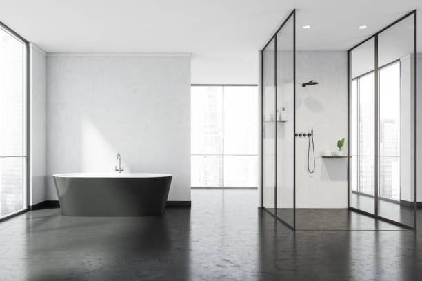 istock White panoramic bathroom space with walkways, black bathtub and glass shower cabin 1341548533