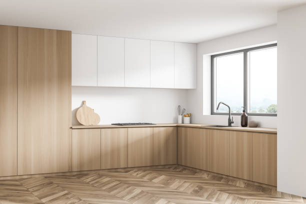istock Modern white kitchen corner with wood materials and window over a sink 1341550406