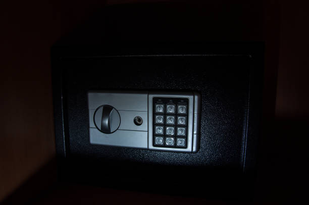 istock Small modern safe on shelf in dark. Small safe box close up in low key light 1341551214