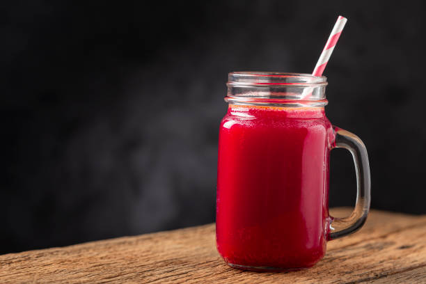 istock Red beet juice in a glass cup on the wooden table. 1341555809
