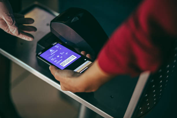 passenger scanning boarding pass on phone at airport - self service stockfoto's en -beelden