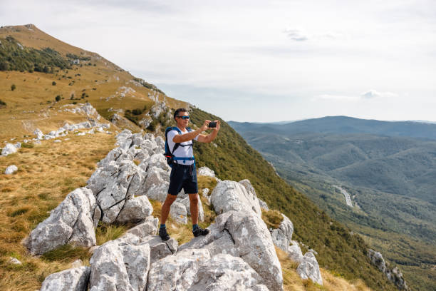 istock Mature Hiker Taking a Selfie in The Mountains 1341562496