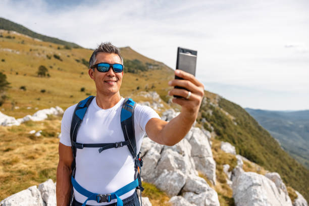 Mature Hiker Taking a Selfie in The Mountains
