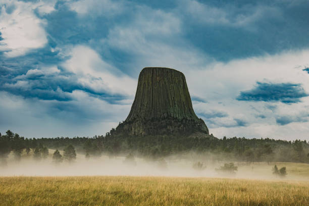 istock Devils Tower shot through a foggy, mist filled field after a thunderstorm 1341564277