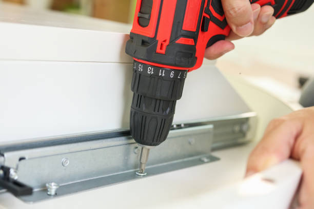 istock man assembling white table furniture at home using cordless screwdriver 1341564281
