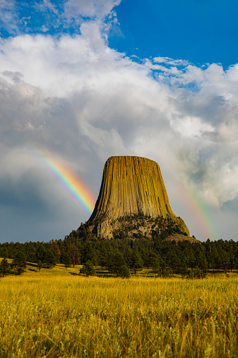 Double rainbow beaming behind Devils Tower National Monument in Wyoming