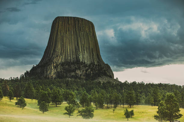 istock Dark and moody image of Devils Tower Monument rock under thunderstorm clouds 1341564638
