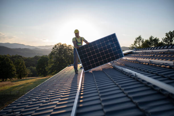workers placing solar panels on a roof - solar roof imagens e fotografias de stock