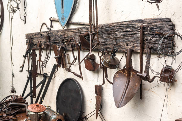 istock Gardening tools and instruments hang on country house wall 1341564704