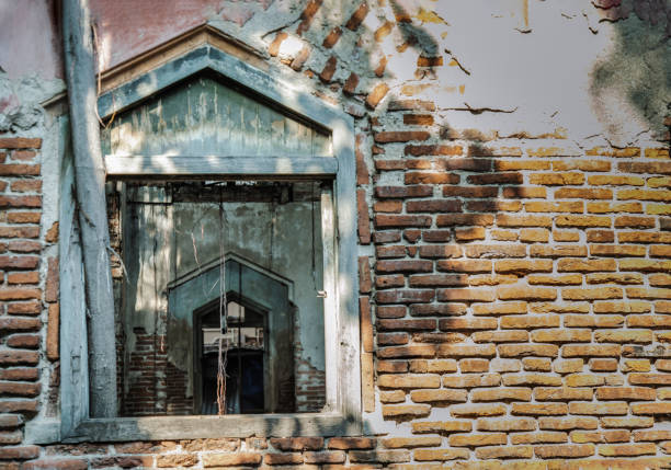 Bangkok, Thailand - 29 Aug 2020 : View through a window frame into an abandoned building was left to deteriorate over time. Traditional Architecture style, Selective focus.