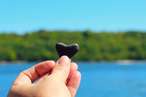 istock Hand holding heart shaped rock 1341568890