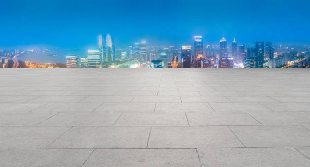 istock Floor tile floor and night view of financial district 1341573757