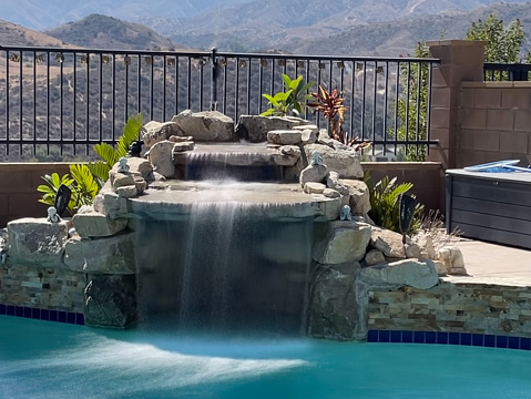 Blurred motion of water cascading down into a home pool