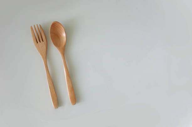 Wooden kitchen ware spoon folk isolated on white background. Single table ware cooking craft product view from top for food decoration and packaging design