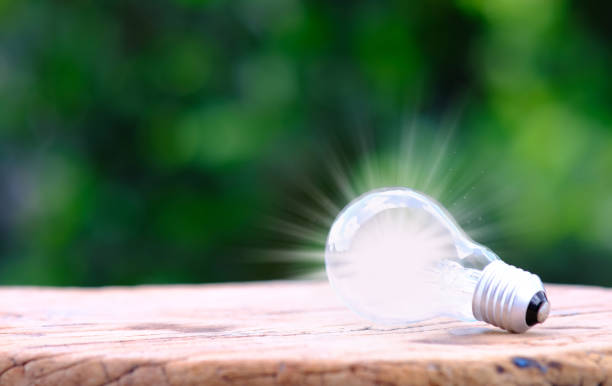 istock Idea innovation and inspiration concept. illuminated light bulb on wooden table, concept creativity with bulb that shine glitter. Inspiration of ideas for sustainable business development 1341581786