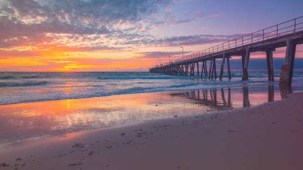 istock Port Noarlunga jetty with people during pink sunset 1341583061