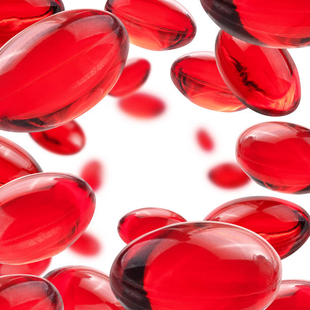 흰색 배경에 빨간 캡슐이 부풀어 오다 - vitamin pill red pill capsule 뉴스 사진 이미지