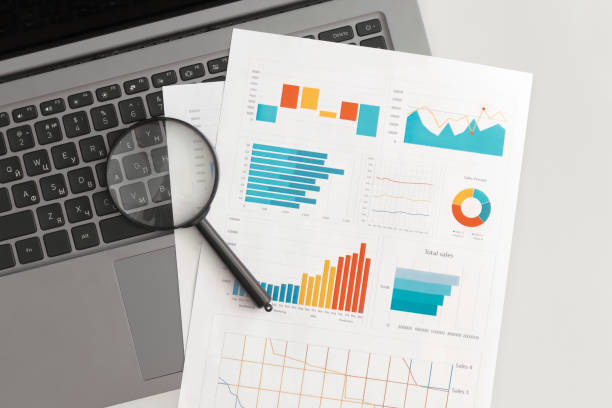 istock Business graphs, charts and magnifying glass on table. Financial development, Banking Account, Statistics 1341588078